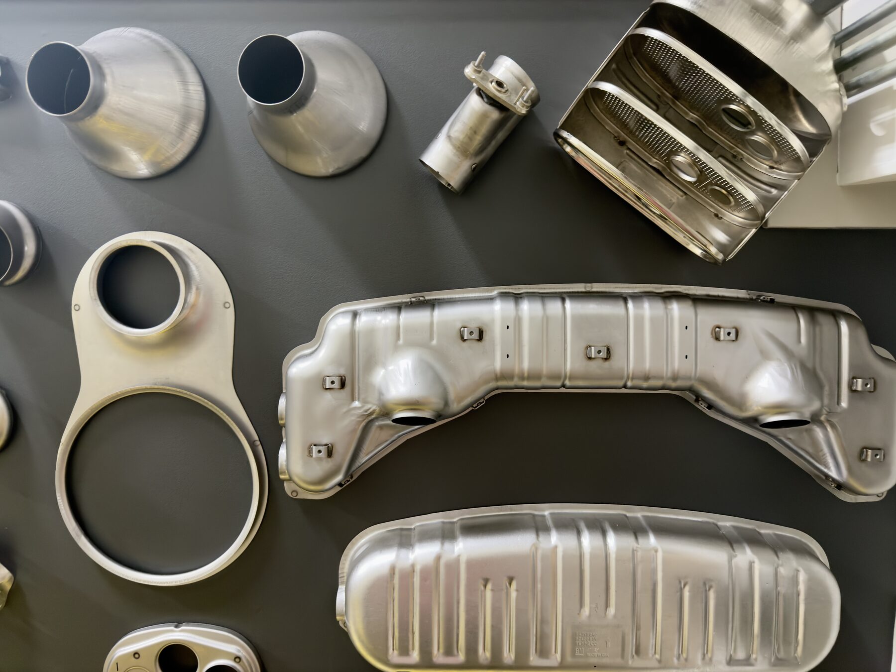 Display of stamped exhaust components manufactured by Big Rapids Products